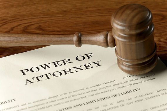 Power of Attorney document with a wooden gavel on a desk, representing the legal authority granted through a power of attorney
