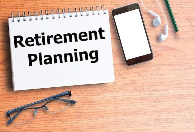 Notepad labeled Retirement Planning with smartphone and glasses, representing digital tools that simplify the process