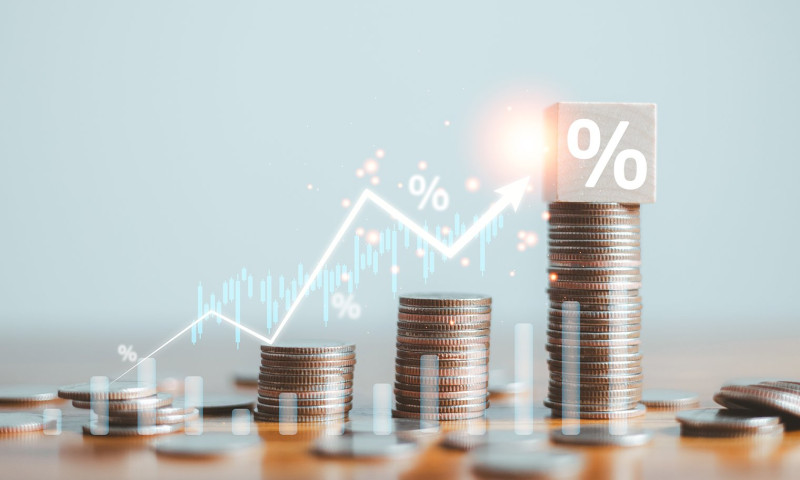 Three coin stacks with a rising percentage graph, showing how interest rate hikes affect retirement portfolios and savings