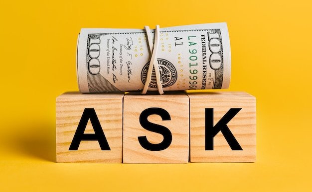 Wooden blocks spelling ASK with a bundle of hundred-dollar bills, answering whether you can have both a 401(k) and an IRA