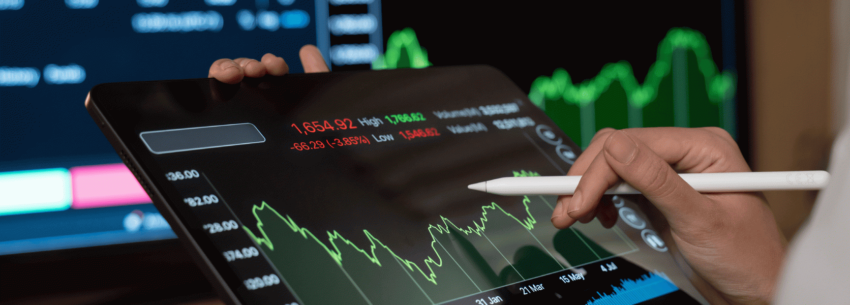 Hand using stylus on a tablet with a green stock chart, managing the urge to chase market gains near retirement
