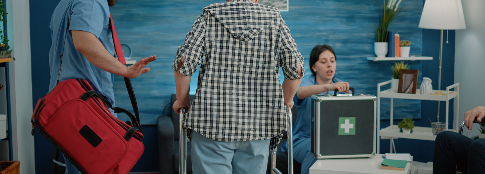 Healthcare workers helping an elderly patient with a walker, navigating how to move states without losing healthcare