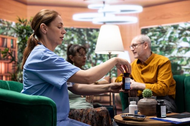 Nurse showing medication to an elderly man at a care facility, helping choose a long-term care facility