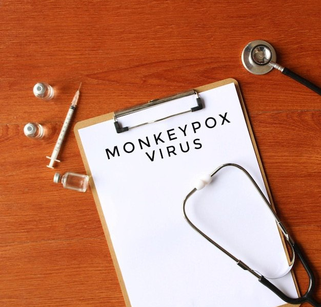 Medical clipboard with stethoscope, syringe, and vials on a wooden surface, representing health fraud awareness